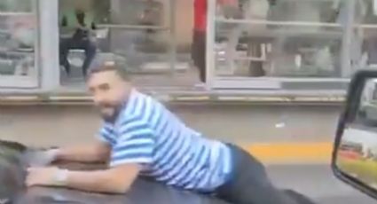 Captan en VIDEO a hombre colgado de un BMW negro en pleno López Mateos en León